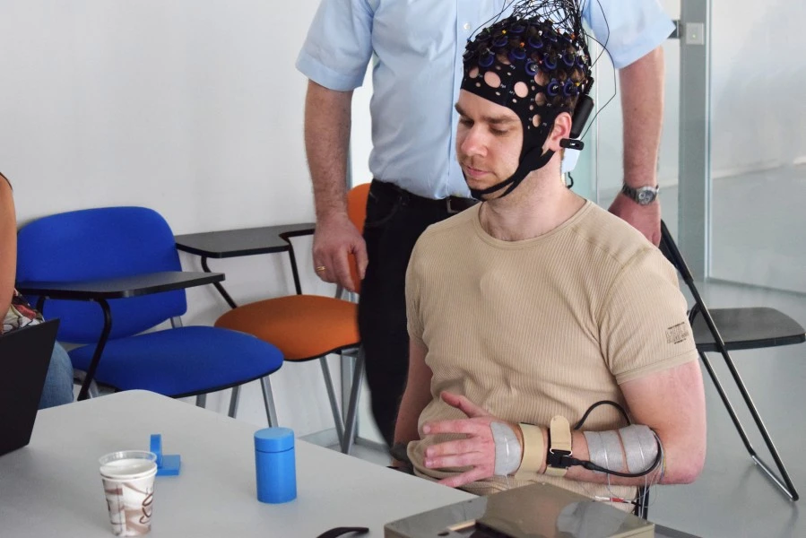 Person With Spinal Cord Injury Wears Neuroprosthesis And Brain-Computer Interface For Arm With Reduced Mobility